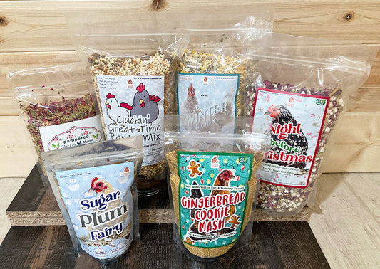 Holiday Goody Box for Chickens with six organic treat bags, including cookies and mash mixes, by Dahlia Pets.