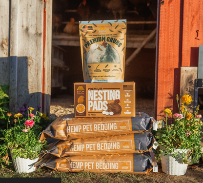 Eaton Pet and Pasture premium chicken coop bundle with hemp bedding, nesting pads, and grubs in a rustic outdoor setting.