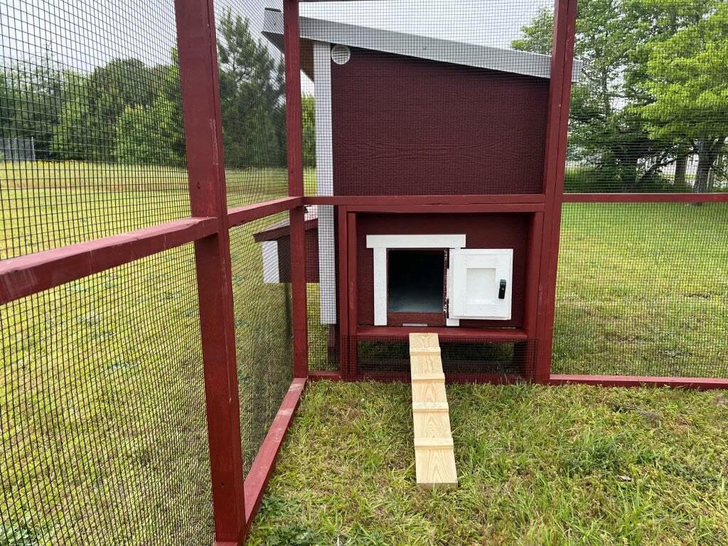 OverEZ 8x8 wooden chicken run with yellow pine frame, featuring a secure entrance and ramp, designed for backyard use.